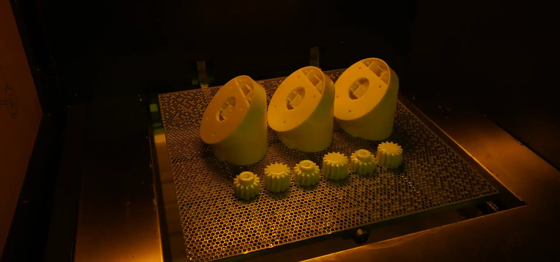 Industrial parts produced with SLA 3D printing technology, displayed inside the SLA machine, showcasing high precision and detail.