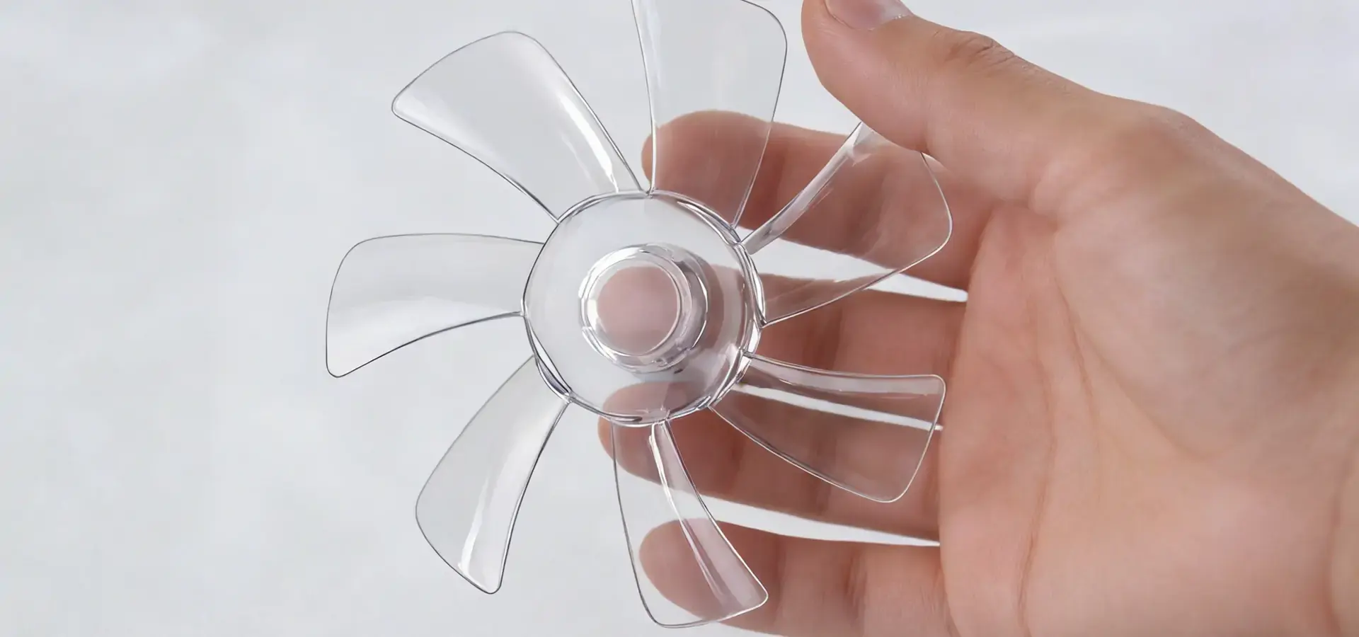 A transparent, intricately detailed fan impeller, demonstrating the high precision and smooth surface quality possible with Stereolithography 3D printers.