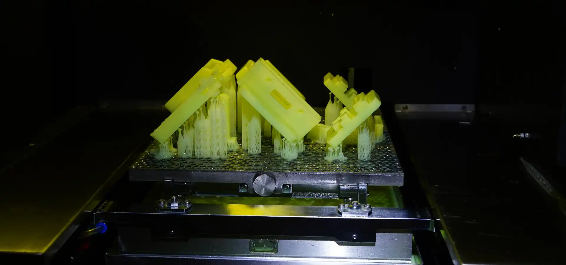 SLA 3D printer in operation, printing a part with the laser curing resin inside the print chamber