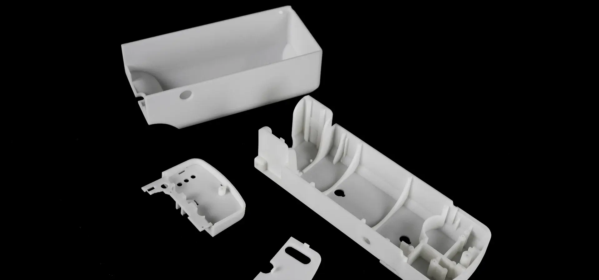 A collection of SLA 3D printed manufacturing parts, demonstrating fine detail and accuracy for industrial applications