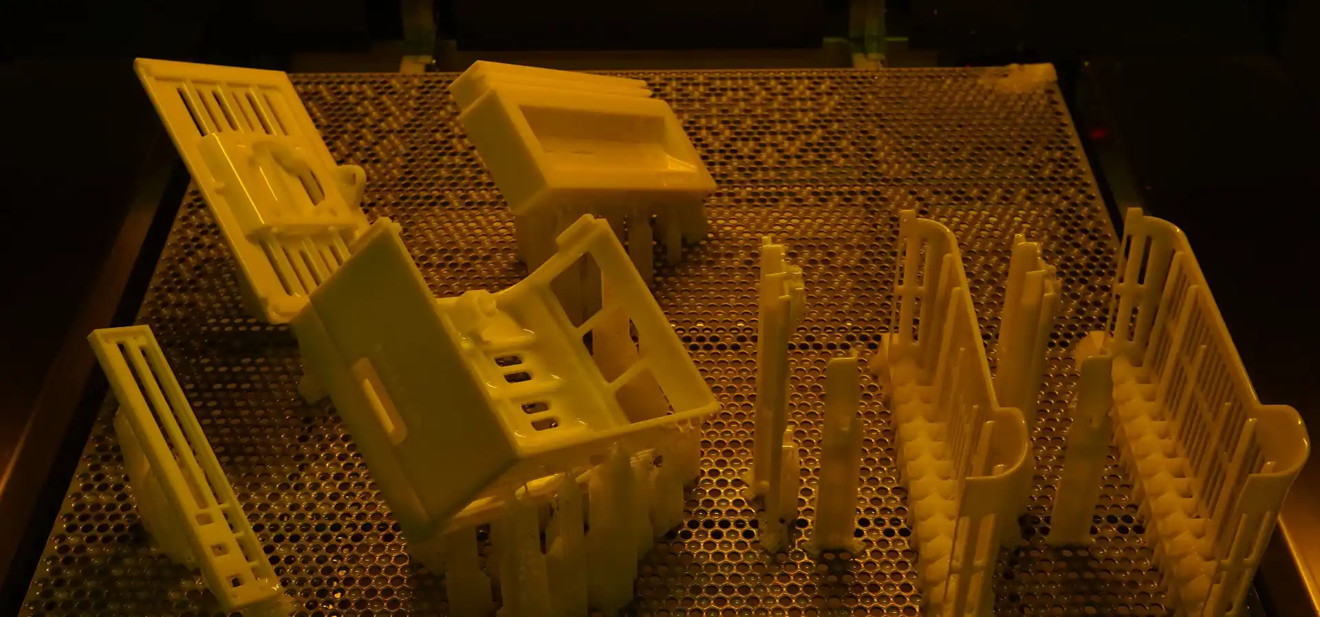 A 3D printed part that has been completed using SLA technology, still inside the machine, ready to be removed