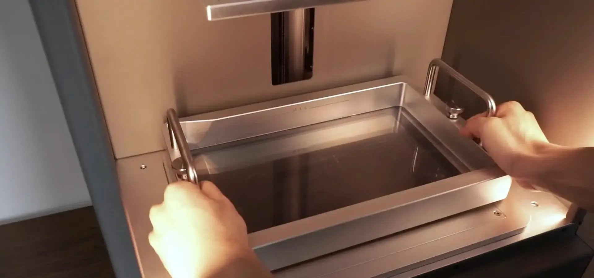 Technician verifying dimensional accuracy of a calibration print from a high resolution 3D printer using digital calipers