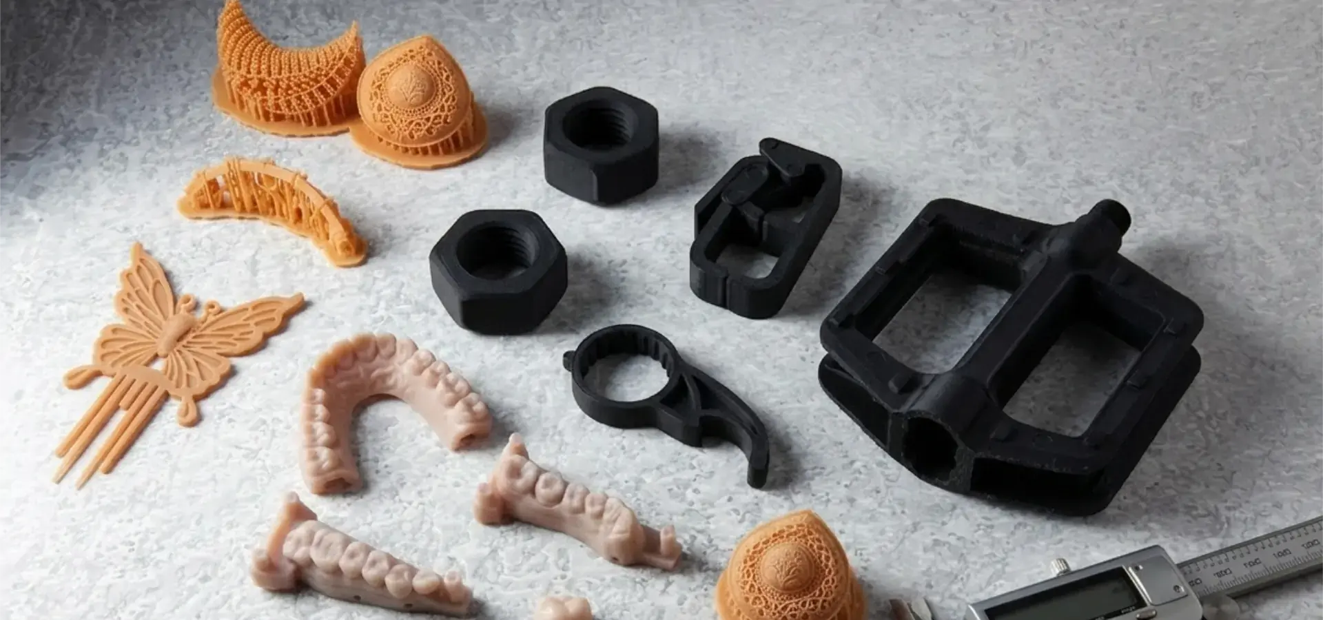 Collage of high resolution 3D printer applications including dental models, jewelry patterns, and engineering prototypes