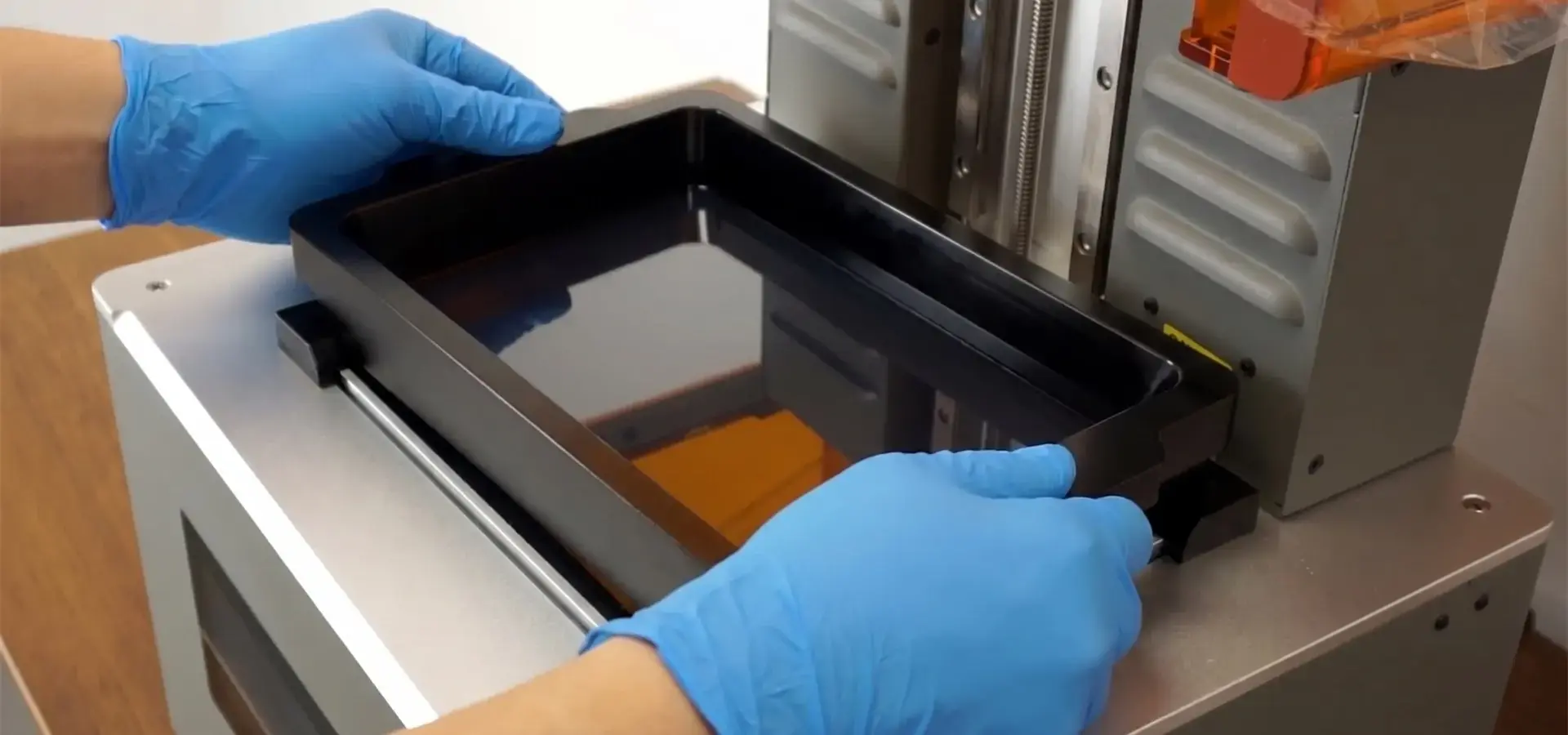 Operator performing maintenance and resin vat replacement on a P10 Pro stereolithography 3D printer Operator performing maintenance and resin vat replacement on a P10 Pro stereolithography 3D printer